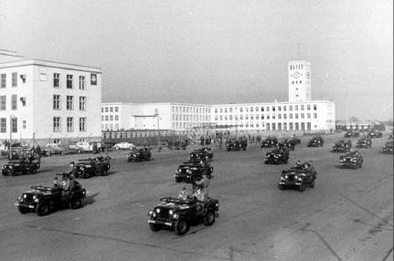 US forces holding a military parade on a stretch of road built according to plans by Albert Speer