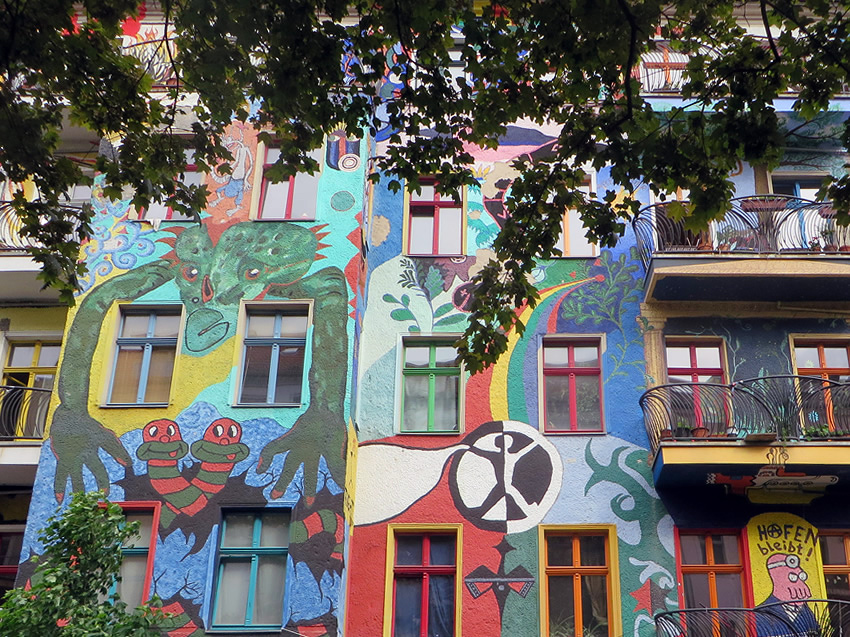 The beautifully painted facade of a former squat is one of Berlin's most famous alternative sights - but it hides a secret