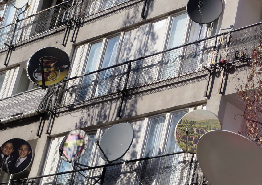 Satellite dish art adorns a Brutalist apartment block in Berlin