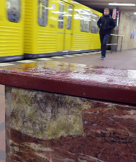 Red marble clads walls, columns and even benches in Mohrenstrasse metro, Berlin